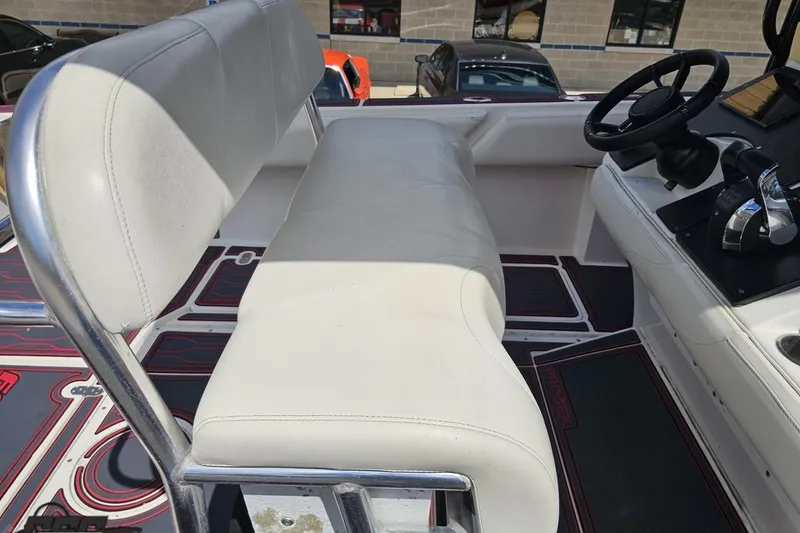 Slide: The Image of 2005 Fountain 34 Sportfish CC Open Bow interior with white seating and steering console. - 63