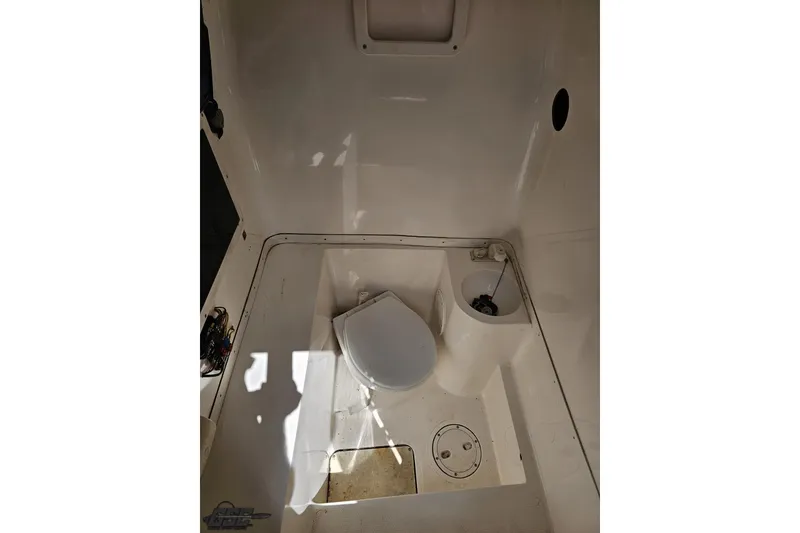 Slide: The Image of 2005 Fountain 34 Sportfish CC Open Bow boat interior with toilet and storage compartment. - 87