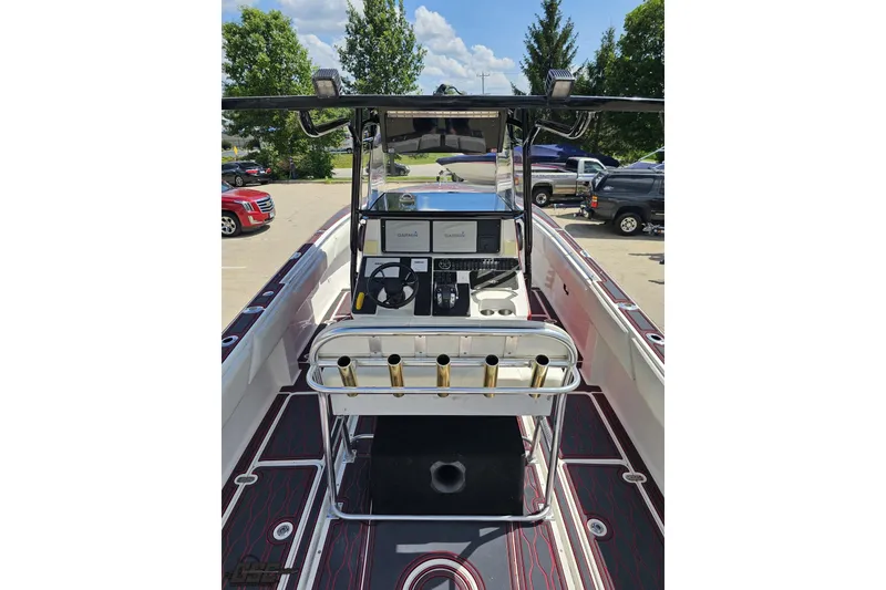 Slide: The Image of 2005 Fountain 34 Sportfish CC Open Bow boat interior with steering console and rod holders. - 51