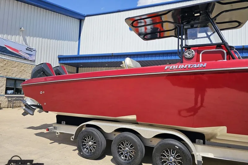Slide: The Image of Red 2005 Fountain 34 Sportfish CC Open Bow boat on trailer outside a building. - 4