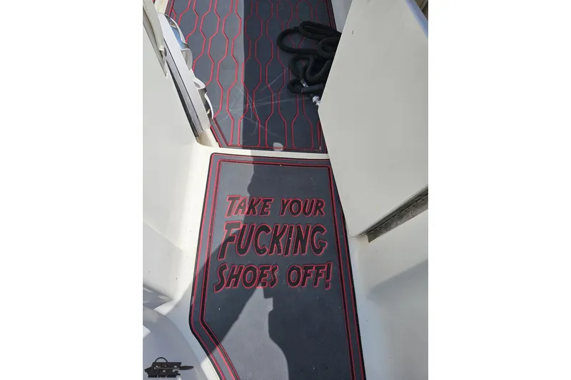 Slide: The Image of 2005 Fountain 34 Sportfish CC Open Bow with humorous floor mat message. - 47