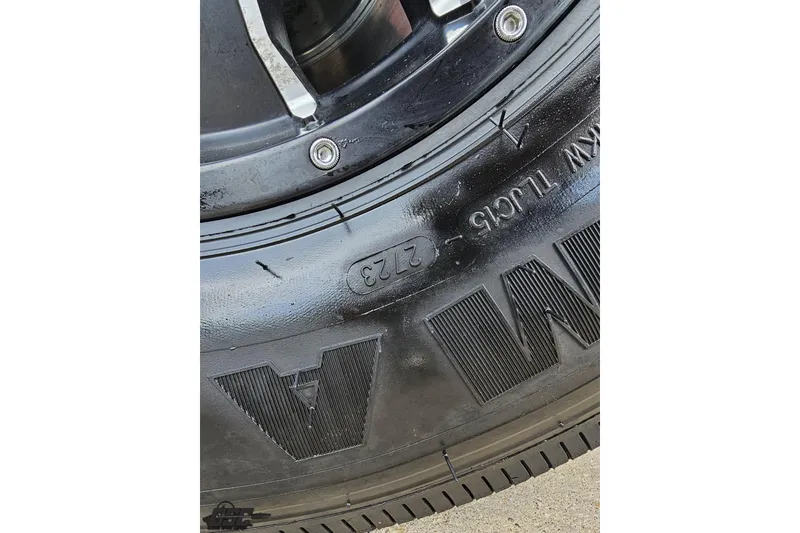 Slide: The Image of Close-up of a black tire with visible tread and markings, 2005 Fountain 34 Sportfish CC Open Bow. - 8