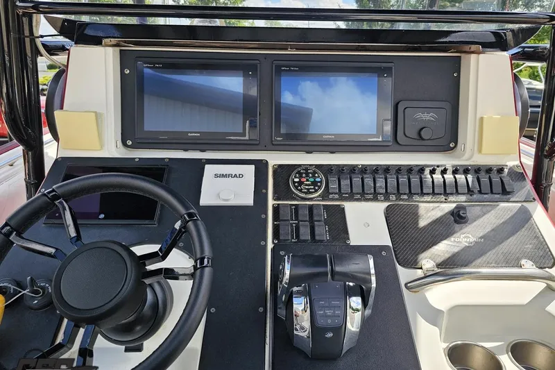 Slide: The Image of Control panel of 2005 Fountain 34 Sportfish CC Open Bow with dual screens and steering wheel. - 65