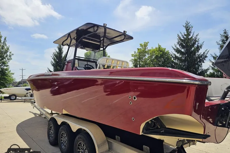 Slide: The Image of 2005 Fountain 34 Sportfish CC Open Bow boat on trailer, red hull, sunny day. - 25