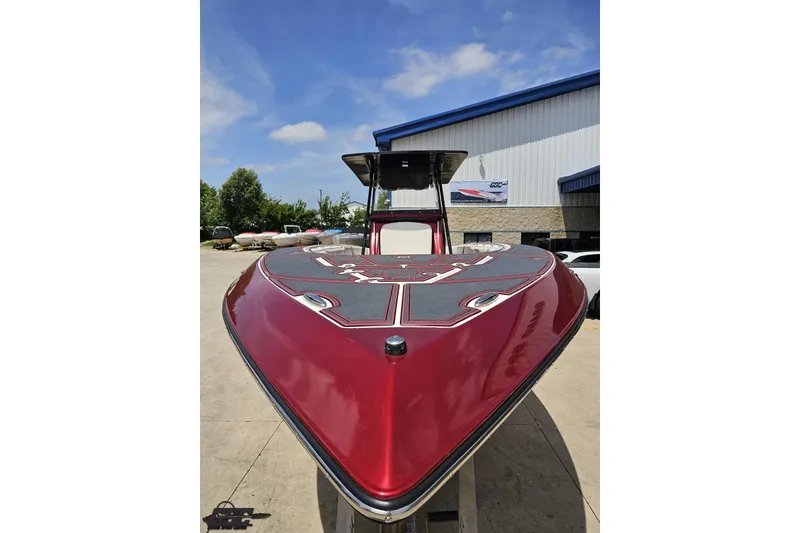 Slide: The Image of 2005 Fountain 34 Sportfish CC Open Bow, red hull, parked outdoors. - 14