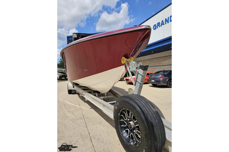 Slide: The Image of 2005 Fountain 34 Sportfish CC Open Bow on trailer, parked outdoors under blue sky. - 13