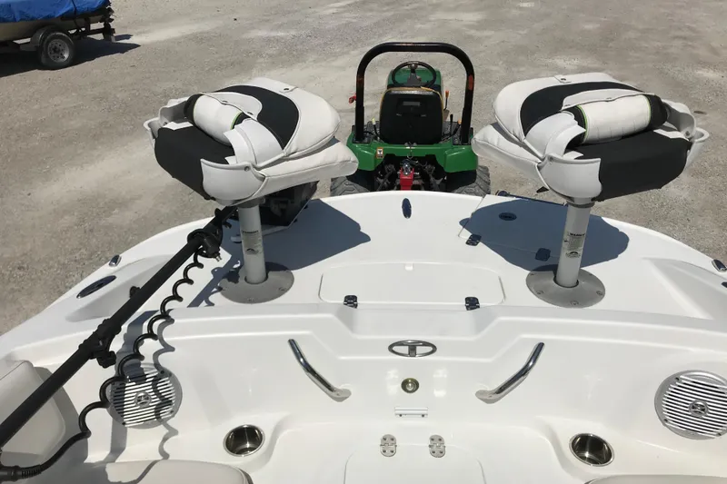 Slide: The Image of Boat interior with two swivel seats, Tahoe 1950 model, 2021, parked on gravel. - 18