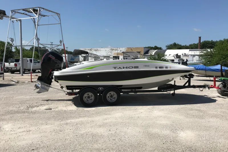 The Image of 2021 Tahoe 1950 boat on trailer in outdoor storage area. - 2