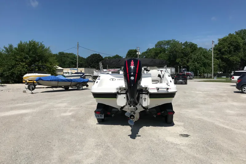 Slide: The Image of 2021 Tahoe 1950 boat parked on gravel lot under clear blue sky. - 5
