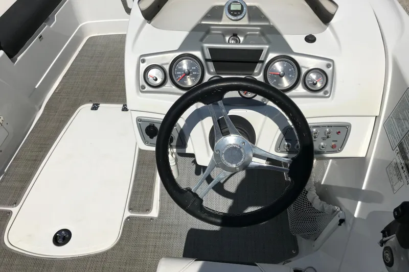 Slide: The Image of Steering console of a 2021 Tahoe 1950 boat with gauges and controls. - 12