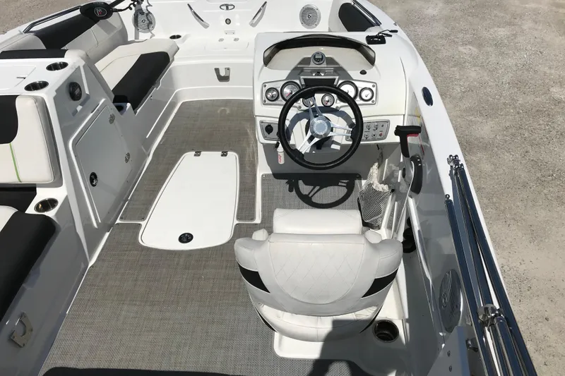 Slide: The Image of Interior of a 2021 Tahoe 1950 boat featuring steering wheel and seating. - 10