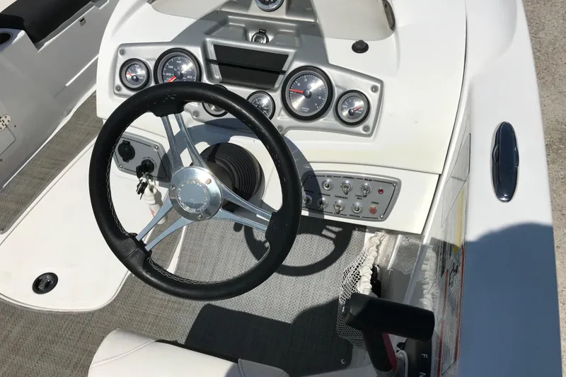Slide: The Image of Steering console of a 2021 Tahoe 1950 boat with gauges and controls. - 11