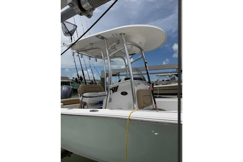 Slide: The Image of 2017 Sportsman Open 212 Center Console boat docked under a clear blue sky. - 1