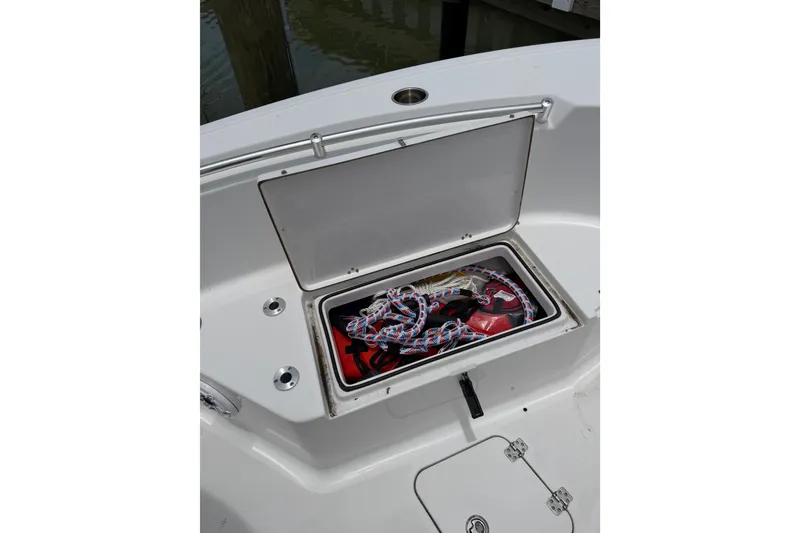 Slide: The Image of 2017 Sportsman Open 212 Center Console storage compartment with ropes and gear. - 7