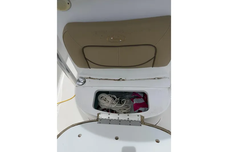 Slide: The Image of 2017 Sportsman Open 212 Center Console boat storage compartment with rope and gear. - 9