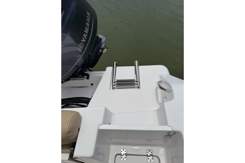 Slide: The Image of 2017 Sportsman Open 212 Center Console boat with Yamaha engine and swim ladder. - 14