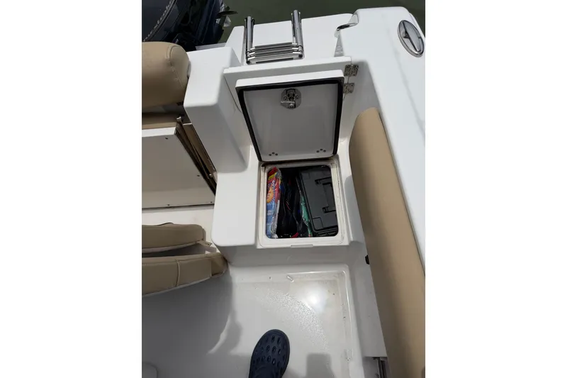 Slide: The Image of 2017 Sportsman Open 212 Center Console boat storage compartment with seating and equipment. - 13