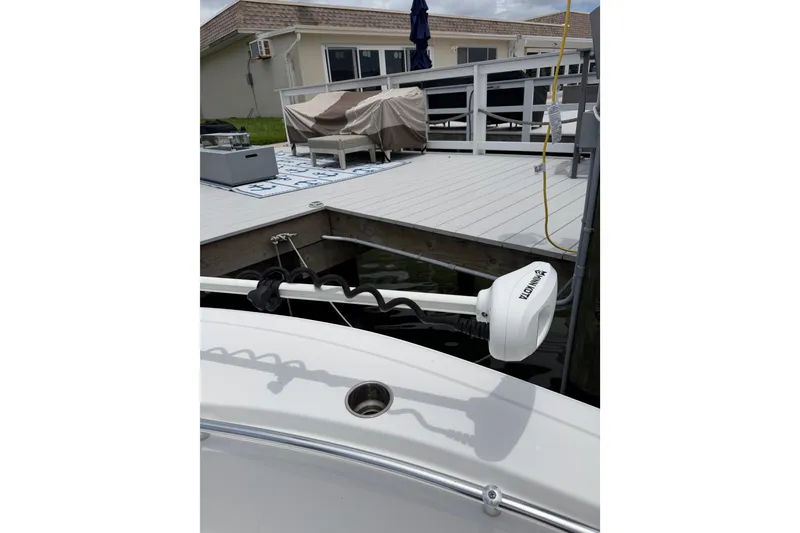 Slide: The Image of 2017 Sportsman Open 212 Center Console boat docked with Minn Kota trolling motor. - 20