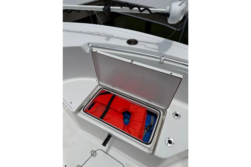 Slide: The Image of 2017 Sportsman Open 212 Center Console with open storage compartment and life jacket. - 10