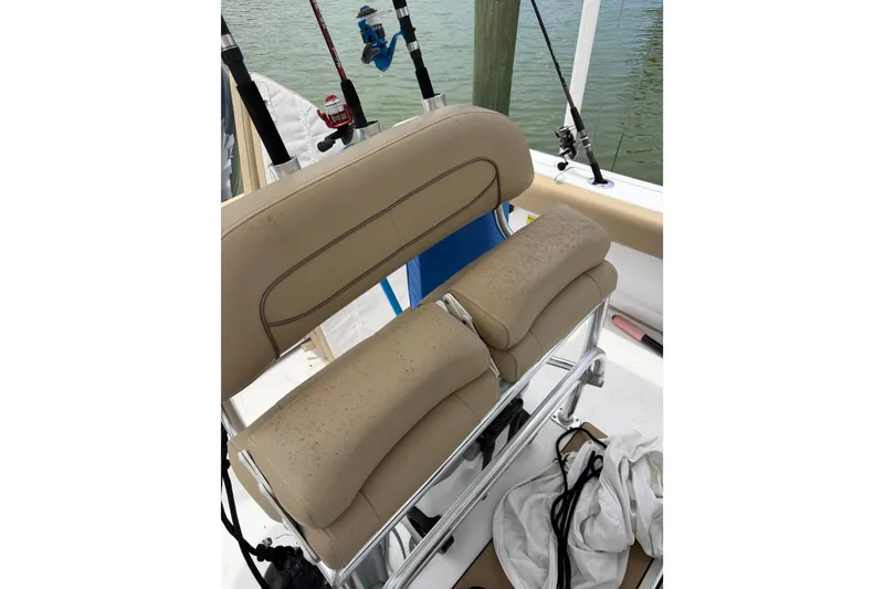 Slide: The Image of 2017 Sportsman Open 212 Center Console boat with beige seating and fishing rods. - 21