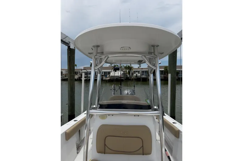 Slide: The Image of 2017 Sportsman Open 212 Center Console boat docked at marina, showcasing helm and seating. - 15
