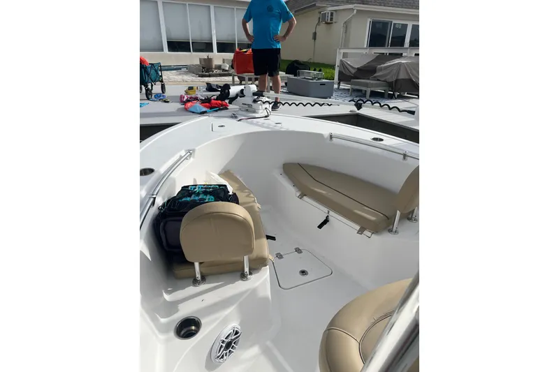 Slide: The Image of 2017 Sportsman Open 212 Center Console boat interior with seating and gear on deck. - 30
