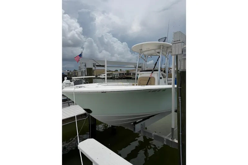 Slide: The Image of 2017 Sportsman Open 212 Center Console boat docked under cloudy skies. - 4