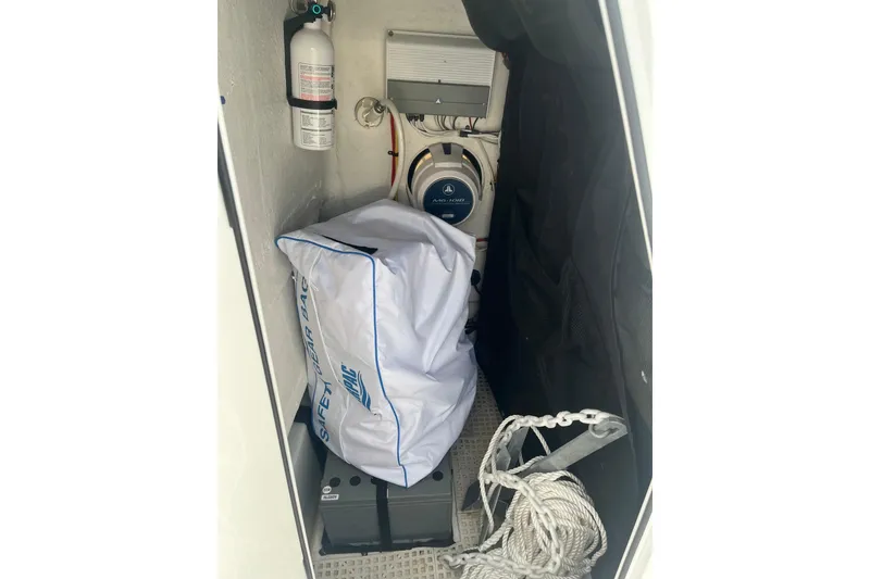 Slide: The Image of Storage compartment of a 2017 Sportsman Open 212 Center Console with safety gear and equipment. - 29