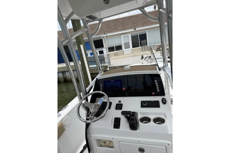 Slide: The Image of 2017 Sportsman Open 212 Center Console boat interior with steering wheel and control panel. - 23