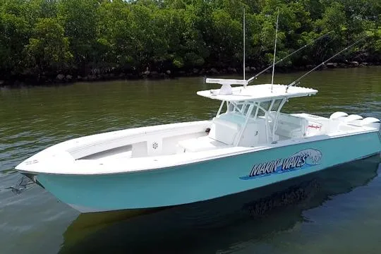 Slide: The Image of 2016 SeaHunter 41 Tournament boat on calm water, surrounded by lush greenery. - 5