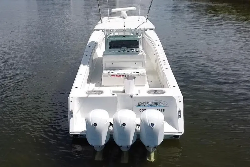 Slide: The Image of 2016 SeaHunter 41 Tournament boat with triple outboard engines on calm water. - 12