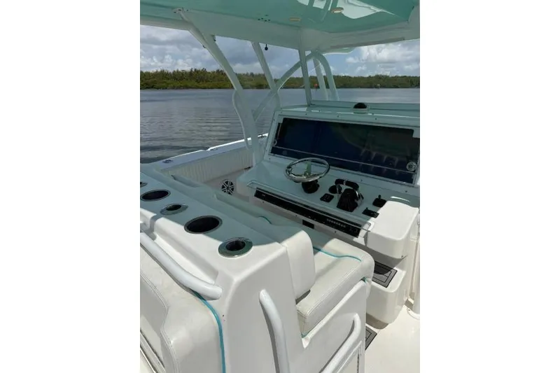 Slide: The Image of 2016 SeaHunter 41 Tournament boat cockpit with steering wheel and control panel. - 25