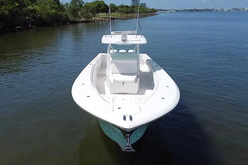 Slide: The Image of 2016 SeaHunter 41 Tournament boat on calm water, showcasing sleek design and spacious deck. - 11
