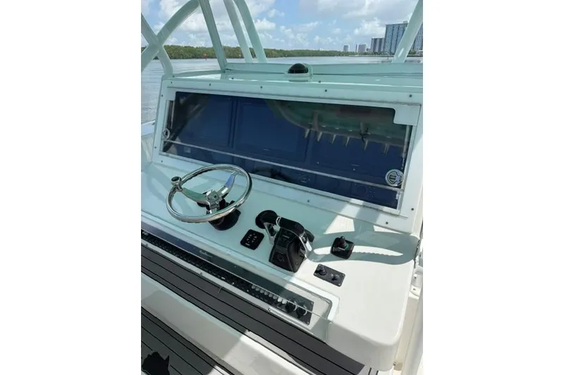 Slide: The Image of Helm of 2016 SeaHunter 41 Tournament boat with steering wheel and controls. - 18