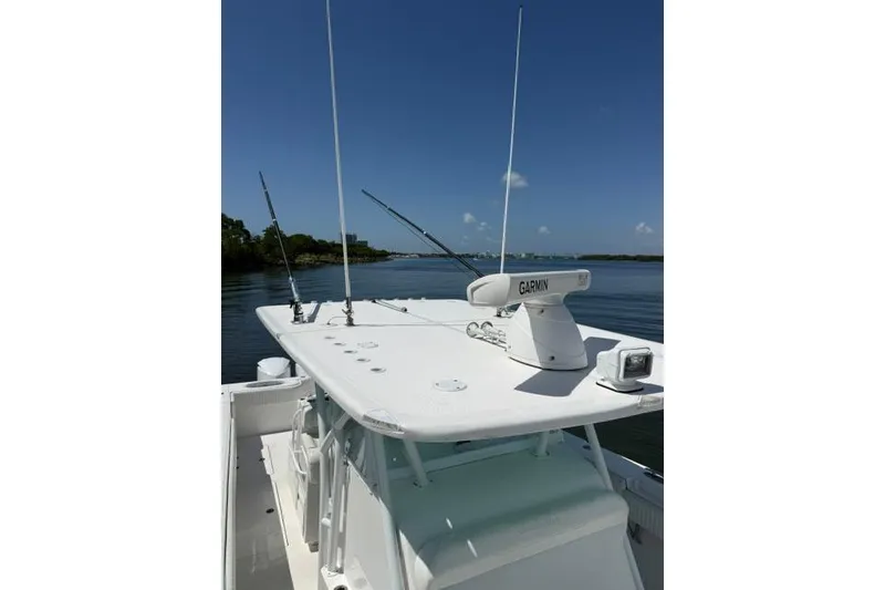 Slide: The Image of 2016 SeaHunter 41 Tournament boat with Garmin radar, fishing rods, and clear blue sky. - 23