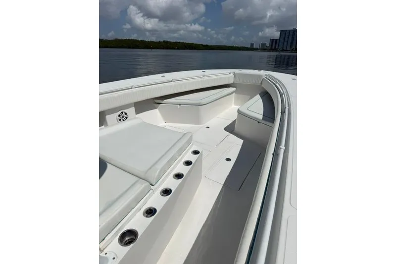 Slide: The Image of 2016 SeaHunter 41 Tournament boat interior with cushioned seating and rod holders. - 19
