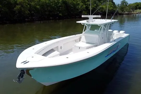 Slide: The Image of 2016 SeaHunter 41 Tournament boat on calm water, featuring sleek design and spacious deck. - 10