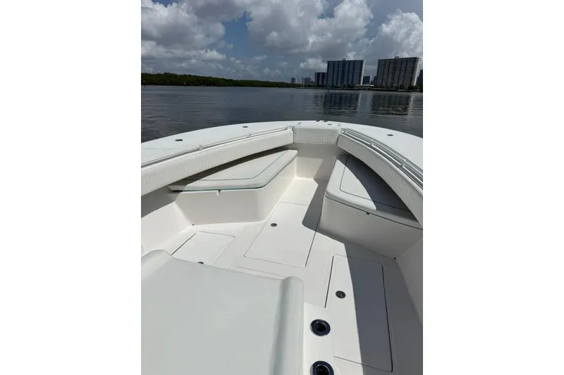 Slide: The Image of 2016 SeaHunter 41 Tournament boat interior with seating, calm water, and city skyline. - 20
