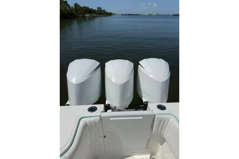 Slide: The Image of Triple outboard engines on a 2016 SeaHunter 41 Tournament boat, overlooking calm waters. - 15