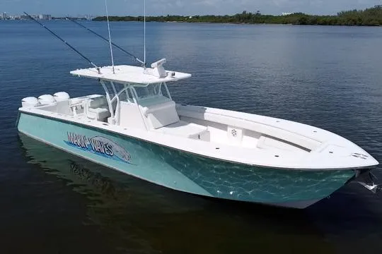The Image of 2016 SeaHunter 41 Tournament boat on calm water, featuring a sleek design and fishing rods. - 1