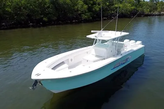 Slide: The Image of 2016 SeaHunter 41 Tournament boat on calm water, featuring sleek design and fishing equipment. - 6