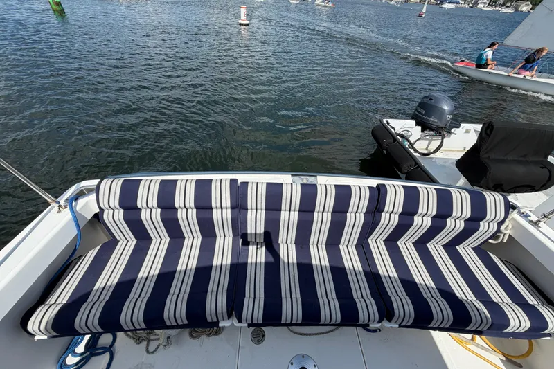 Slide: The Image of Striped seating on a 2004 Back Cove 29 boat, overlooking a scenic waterway. - 5