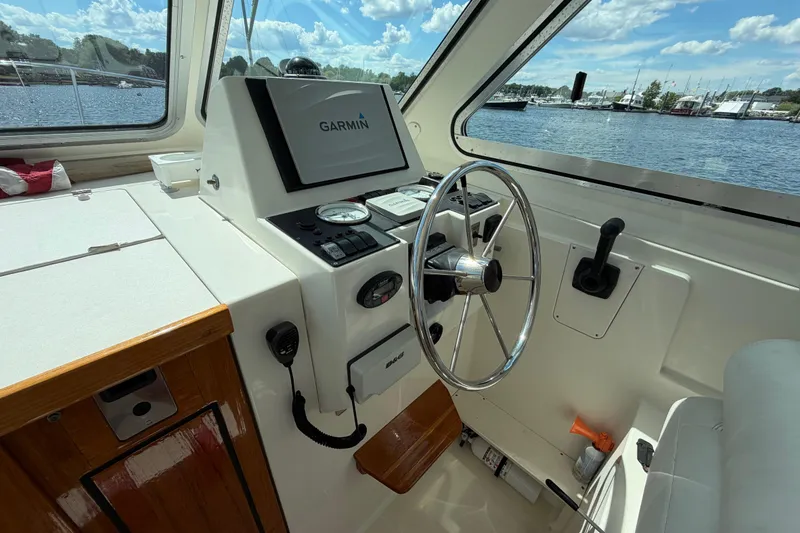 Slide: The Image of Interior helm of 2004 Back Cove 29 boat with Garmin navigation system. - 11