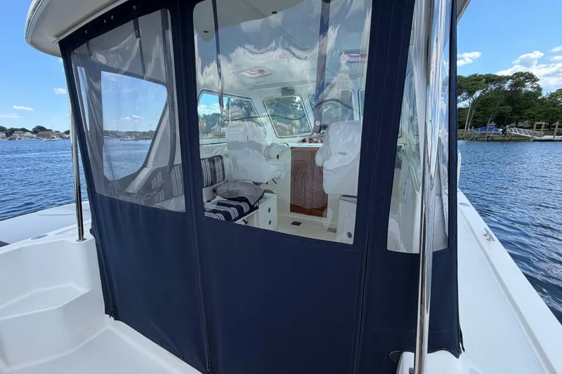 Slide: The Image of 2004 Back Cove 29 boat with enclosed cockpit on calm water. - 6