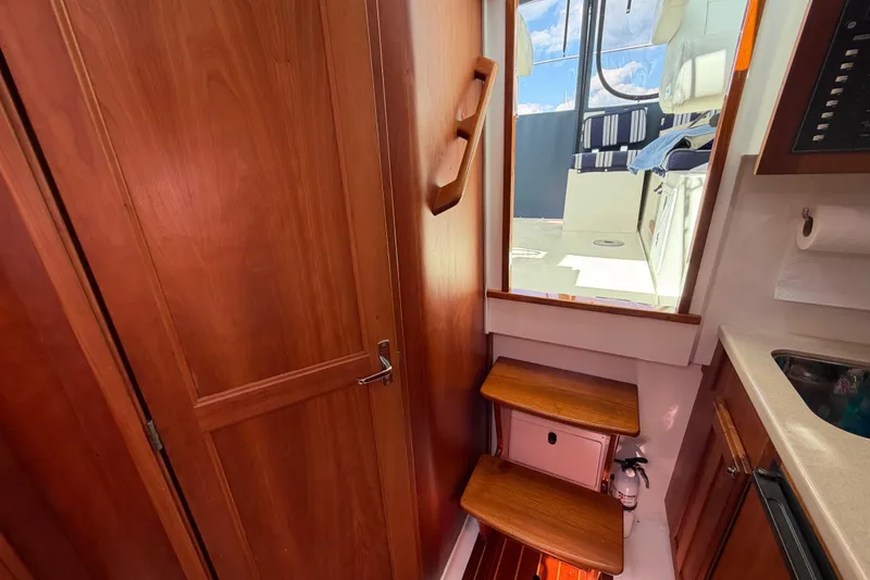 Slide: The Image of Interior view of 2004 Back Cove 29 boat with wooden steps and cabinetry. - 15