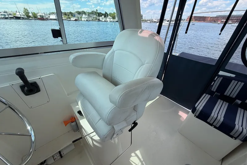 Slide: The Image of Captain's chair on 2004 Back Cove 29 boat, overlooking marina through windows. - 9