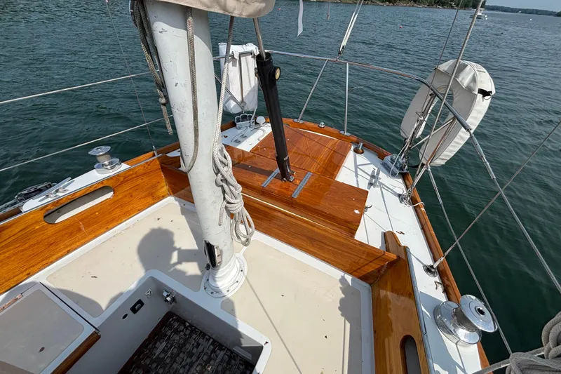 Slide: The Image of 1974 Hinckley Bermuda 40 MKIII sailboat deck with polished wood and nautical equipment. - 17