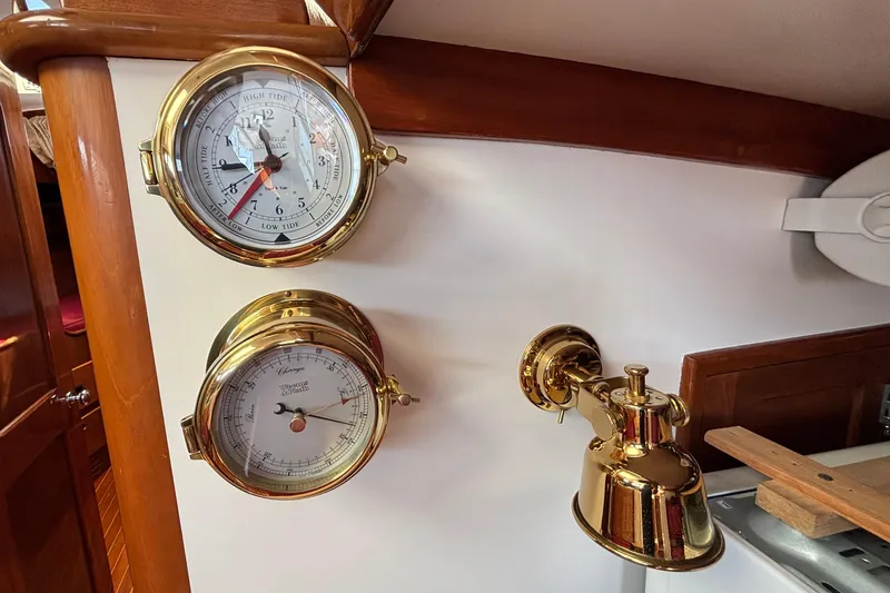 Slide: The Image of Brass tide and barometer gauges on 1974 Hinckley Bermuda 40 MKIII yacht interior. - 42