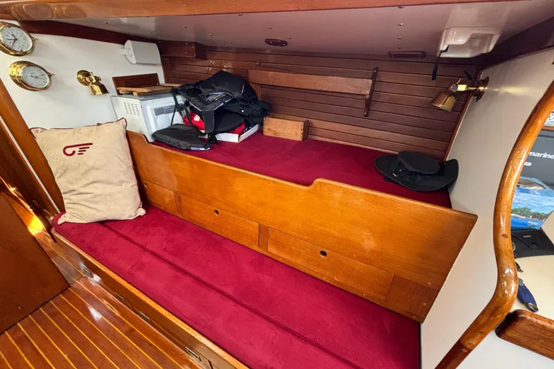 Slide: The Image of Interior of 1974 Hinckley Bermuda 40 MKIII sailboat with red cushions and wooden accents. - 26