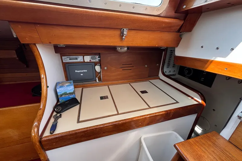 Slide: The Image of 1974 Hinckley Bermuda 40 MKIII yacht interior with navigation equipment and wooden cabinetry. - 34